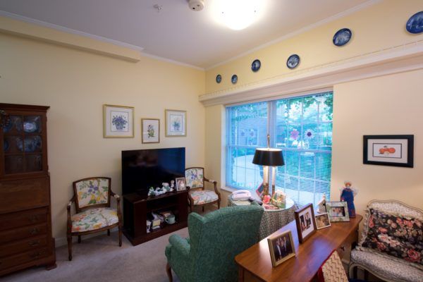 A cozy living room with seating, television, and decorative accents.