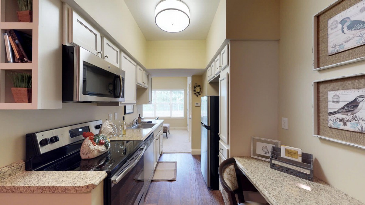 A modern kitchen with sleek appliances and ample cabinet space.