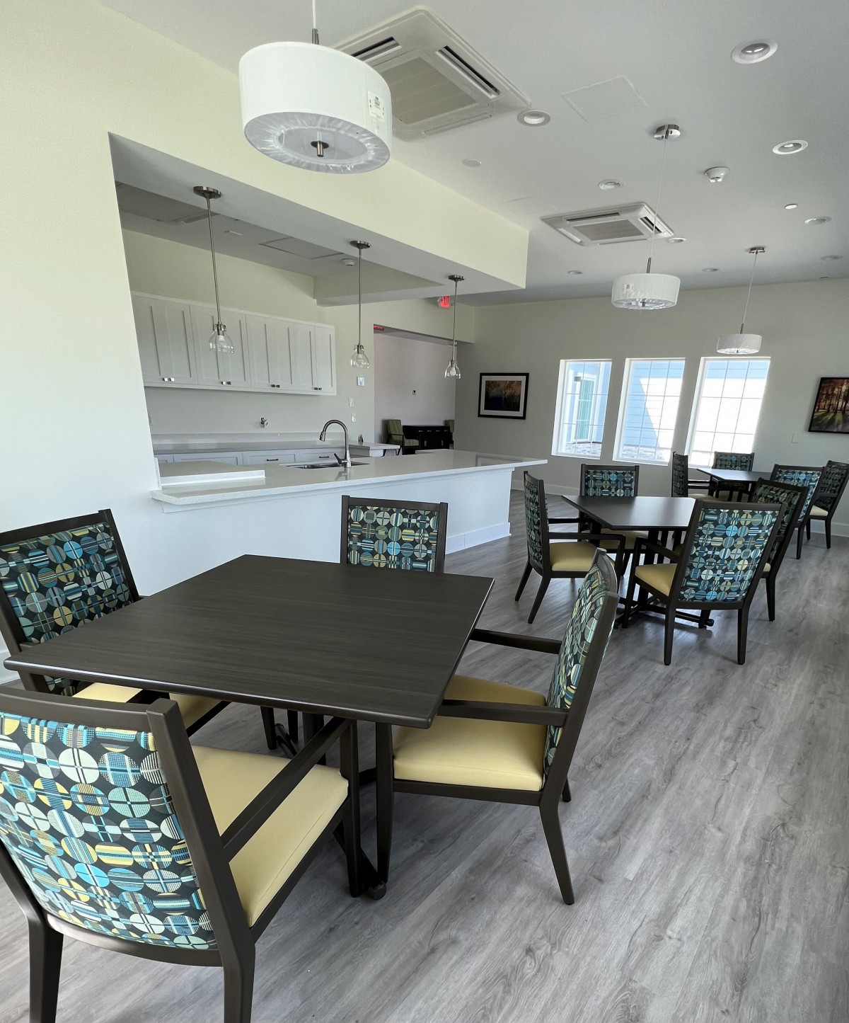 A modern kitchen and dining area with stylish furniture and ample lighting.