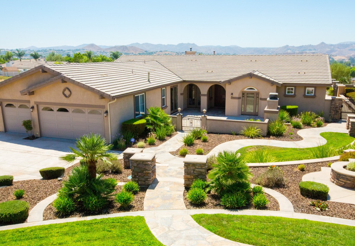 A beautiful house with a well-maintained garden and pathway.