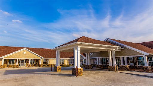 A beautifully designed residential building under a bright blue sky.