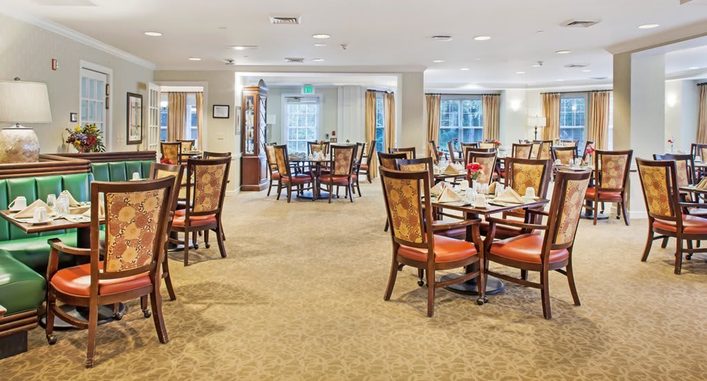 An elegant dining room with neatly arranged tables and chairs, ready for guests.