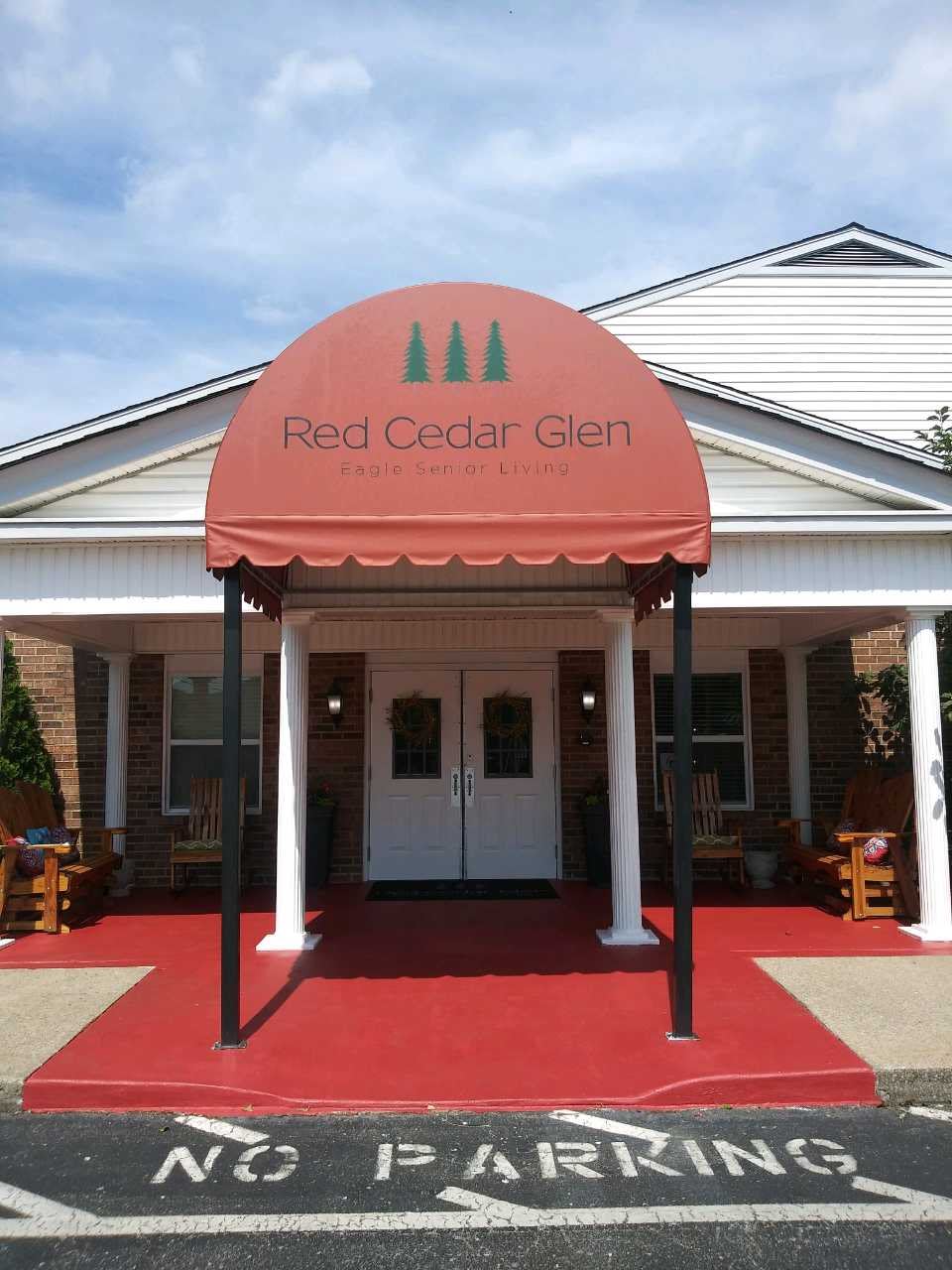 The entrance to the Red Cedar Inn features a distinctive red awning.