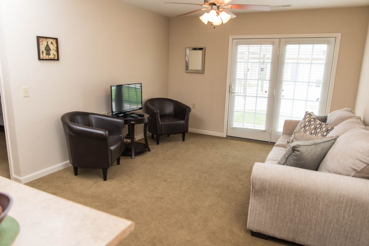 A cozy living room with comfortable seating and a television.