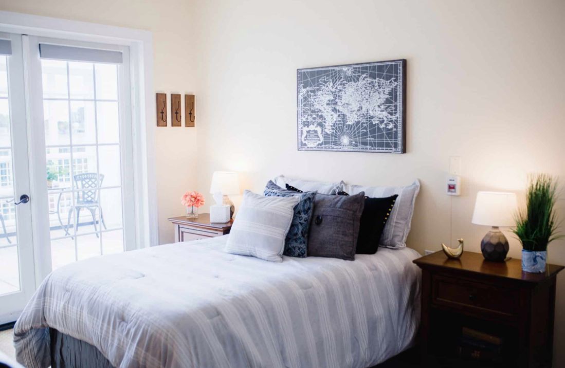 A cozy and modern bedroom with stylish decor and comfortable bedding.