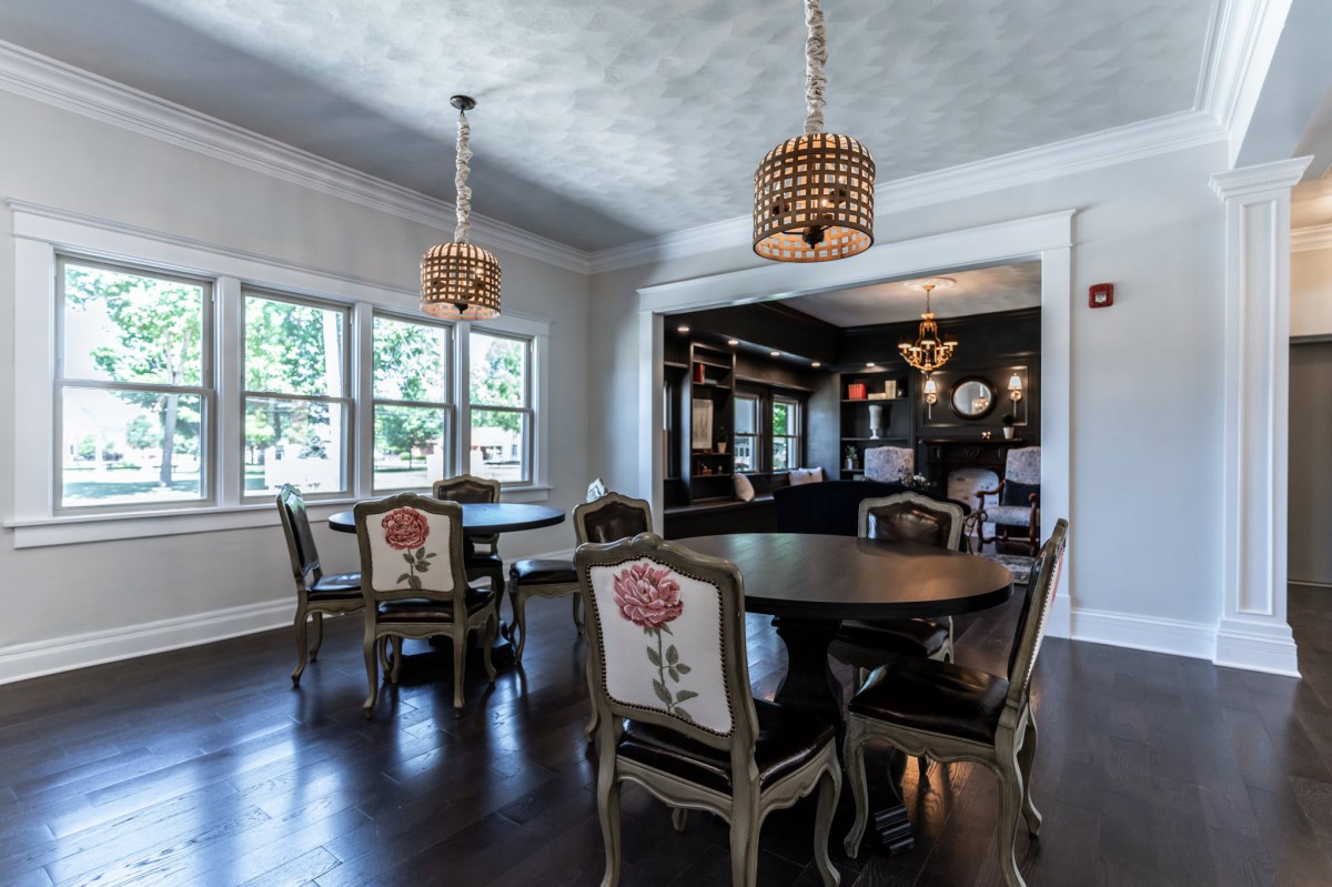 A beautifully designed dining room featuring elegant furniture and chandelier lighting.