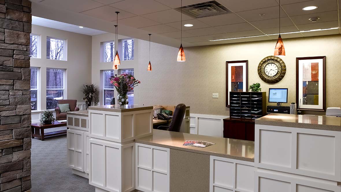 A reception area with desks and decor, featuring a welcoming office environment.
