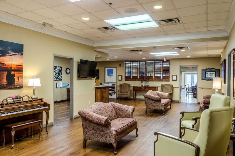 A spacious lobby with comfortable seating and a television.