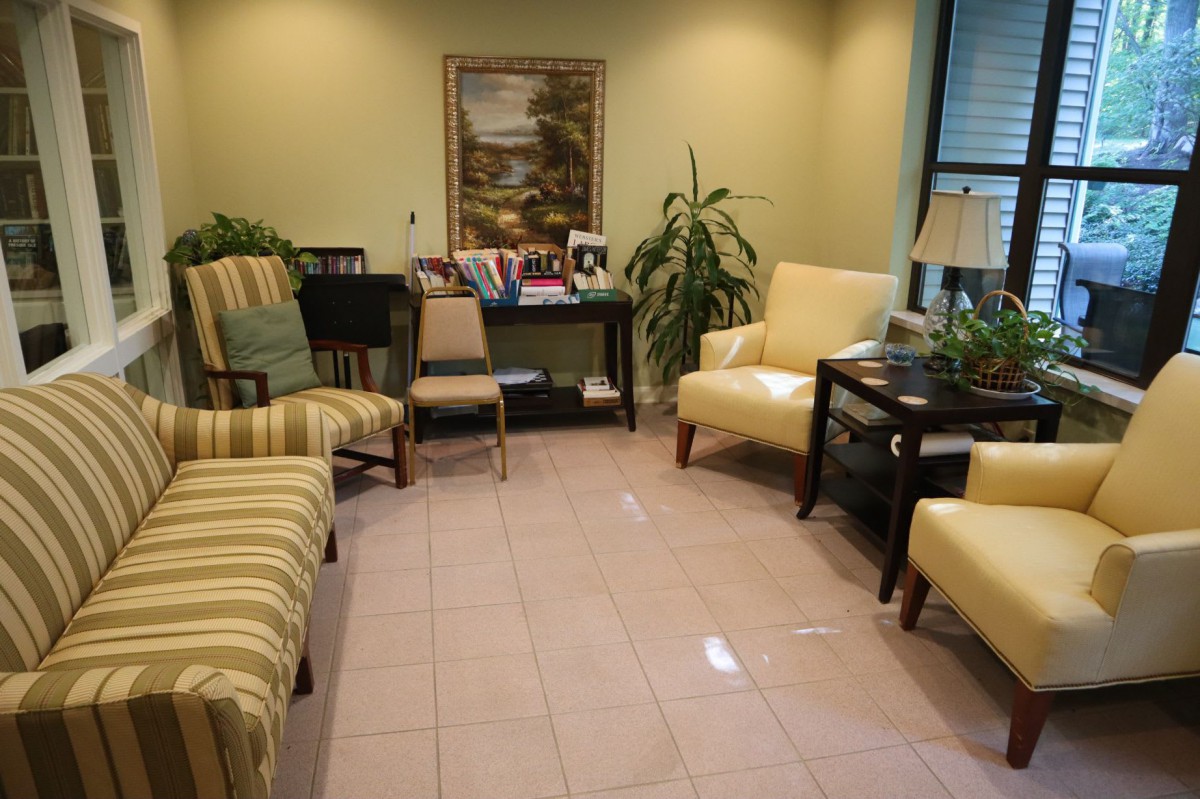 A cozy waiting room with comfortable seating and decorative plants.