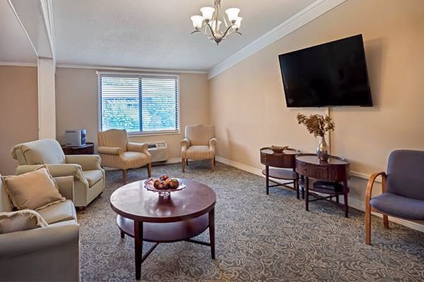 A cozy living room with comfortable seating, a large TV, and a coffee table.