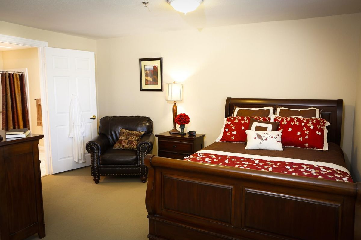 Cozy bedroom with elegant wooden furniture and decorative accents.