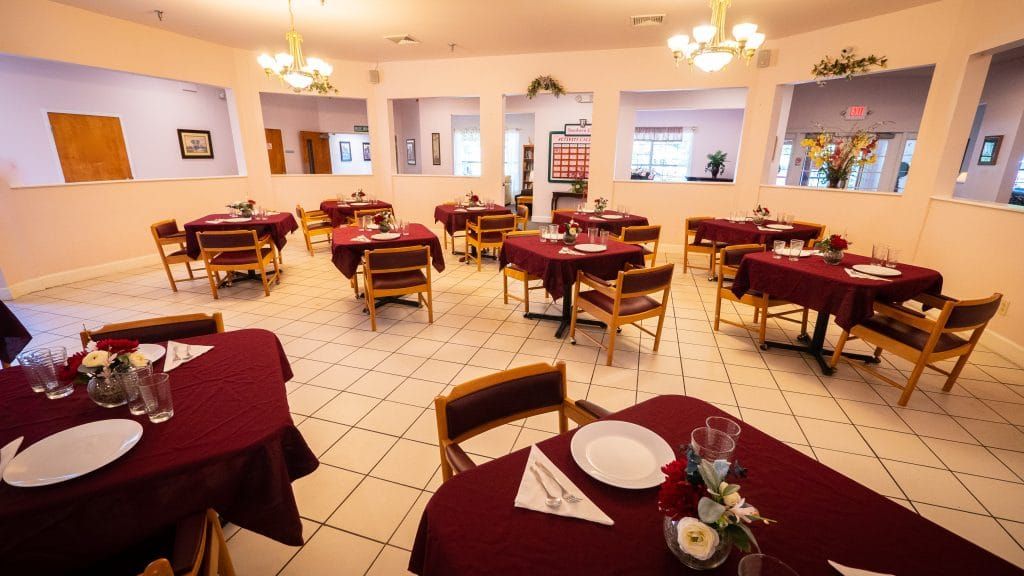 A cozy restaurant interior with neatly arranged tables and chairs, prepared for dining.