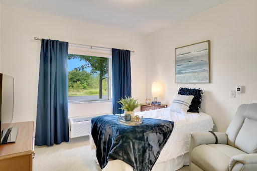 A cozy and modern bedroom featuring a serene view through the window.