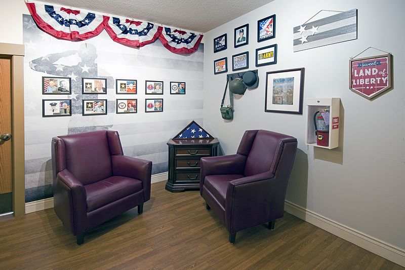 A cozy room featuring patriotic decor, including an American flag display and memorabilia honoring veterans.