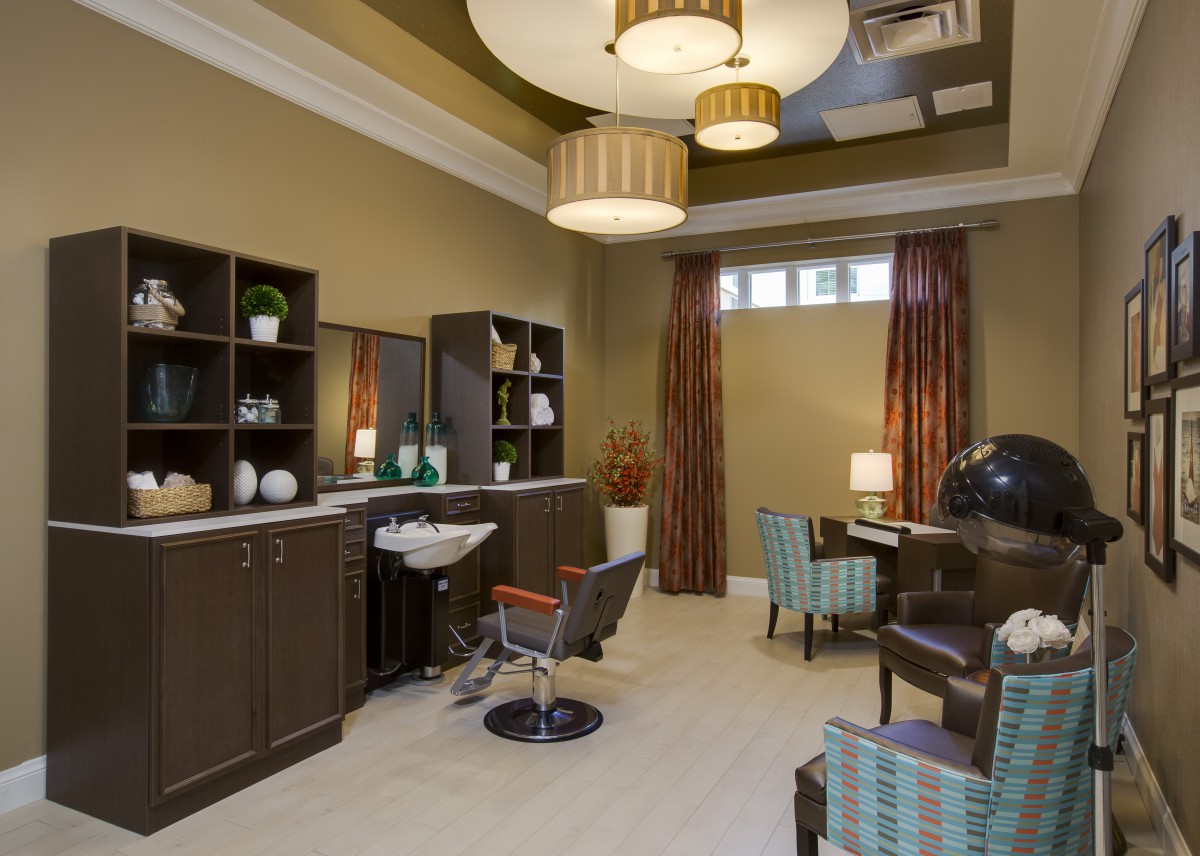 A modern salon interior with stylish furniture and warm lighting.