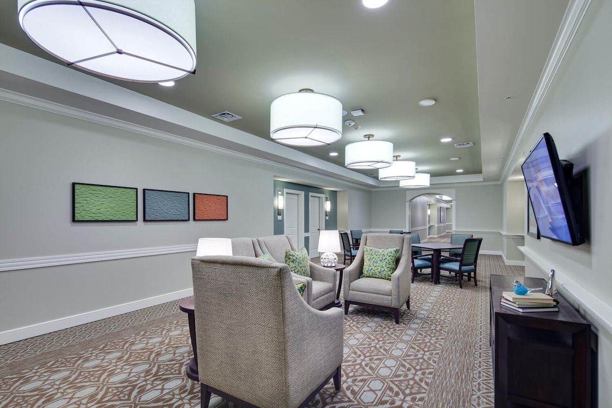 A modern lobby with comfortable seating and elegant lighting fixtures.