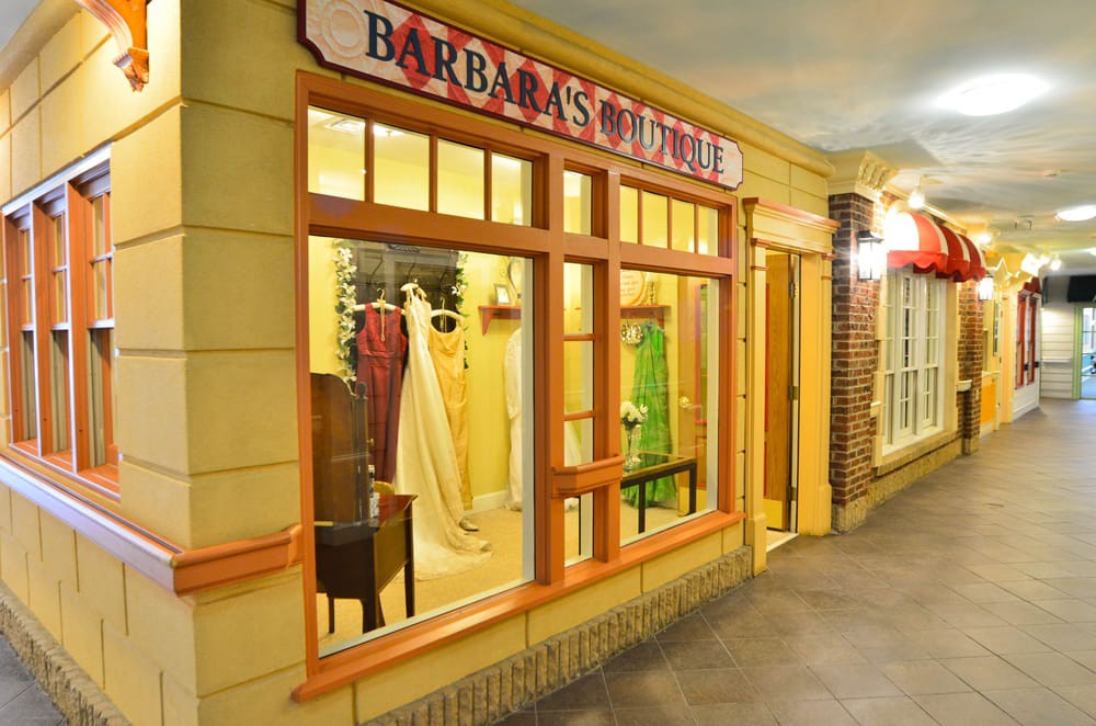 A charming bridal boutique with a window display featuring elegant wedding dresses.