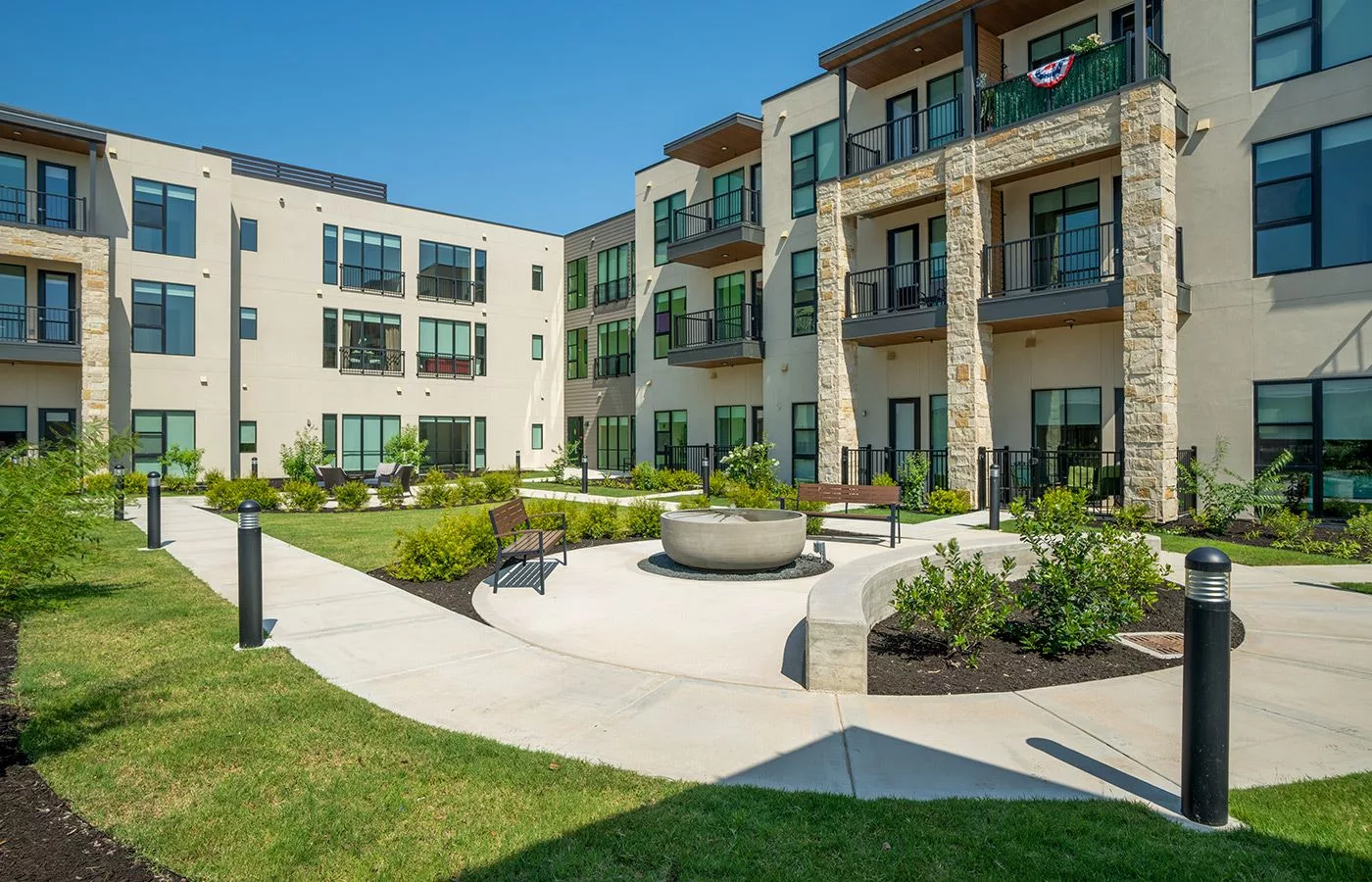 A modern apartment complex with a landscaped courtyard.