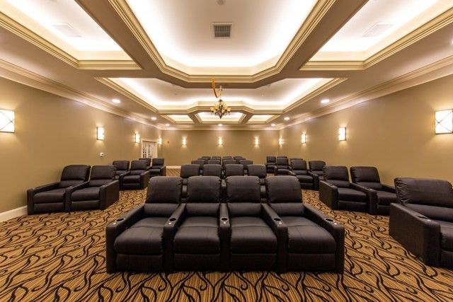 A luxurious home theater with comfortable leather seating and elegant lighting.