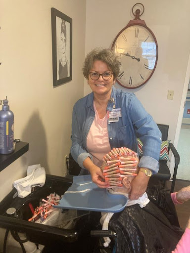 A cheerful woman engaged in an activity indoors, showcasing her warm personality.
