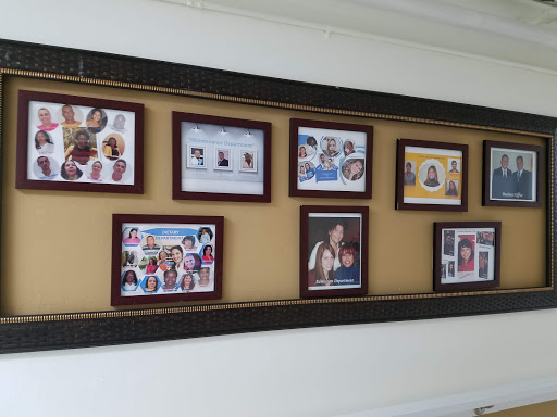 A beautiful wall collage showcasing a variety of family photographs in elegant frames.