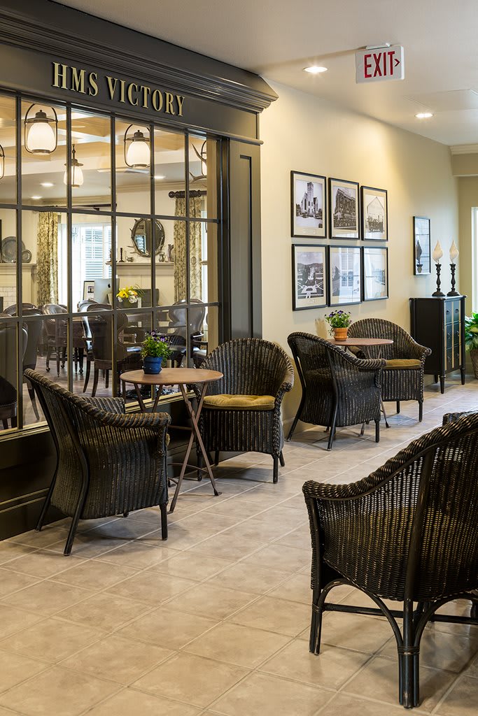 A cozy indoor seating area with wicker chairs and a warm, modern decor.