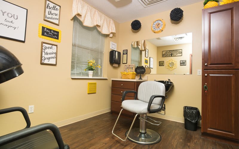 Cozy hair salon interior with a styling chair and mirror.