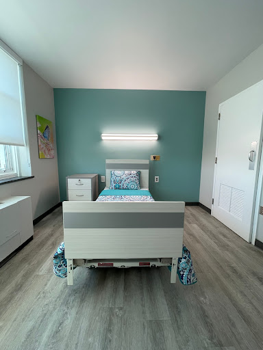 A modern, clean hospital room equipped with a patient bed and minimalist decor.