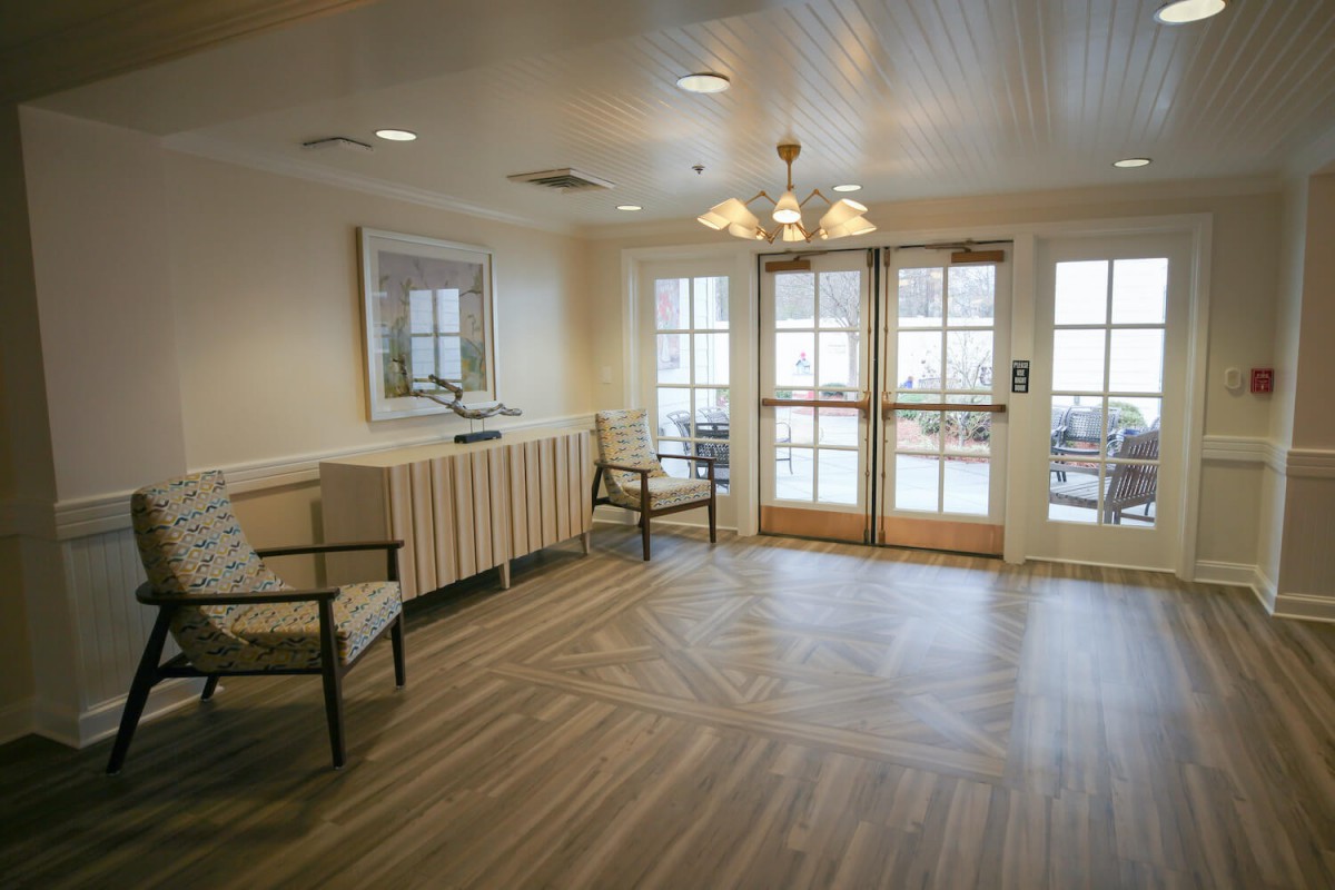 A spacious waiting room with ample natural light and elegant furnishings.