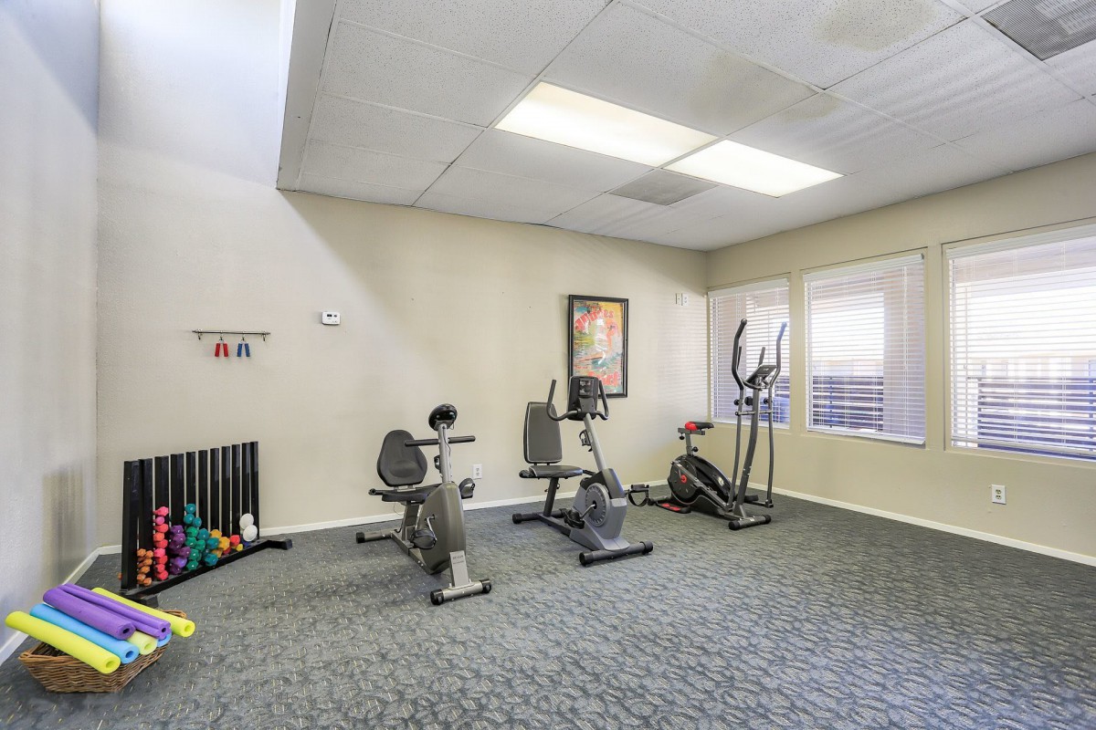 A small gym area equipped with exercise bikes and an elliptical machine.