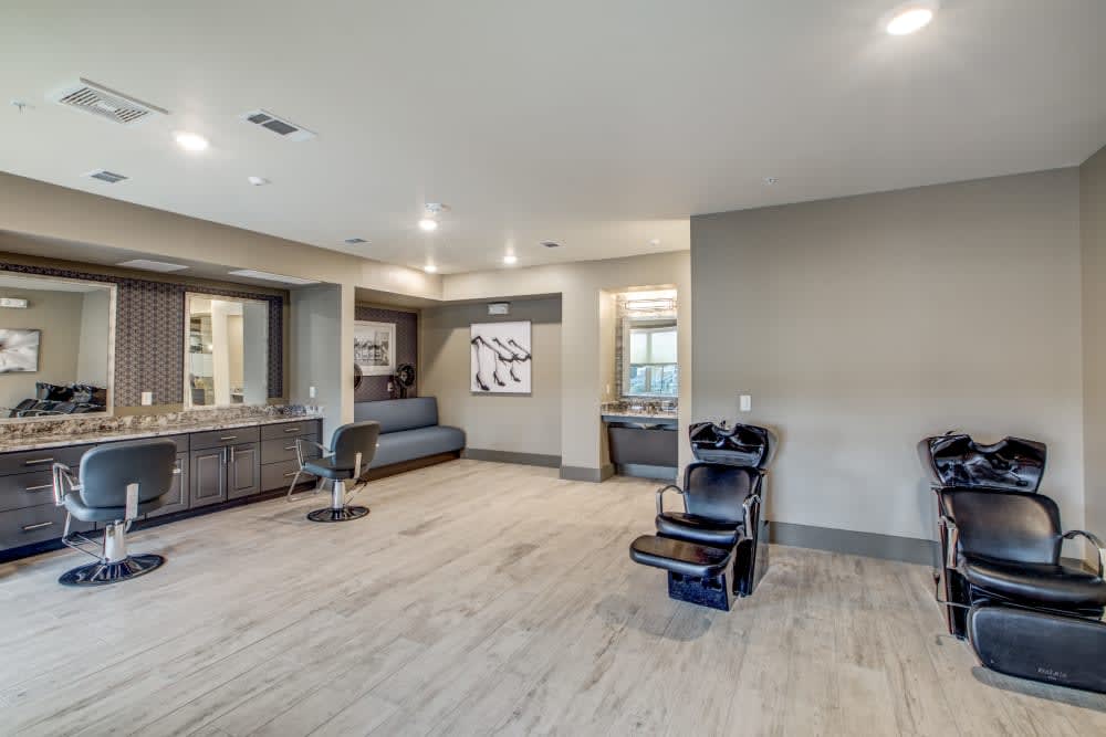 A modern and minimalist salon interior with sleek furniture and spacious layout.