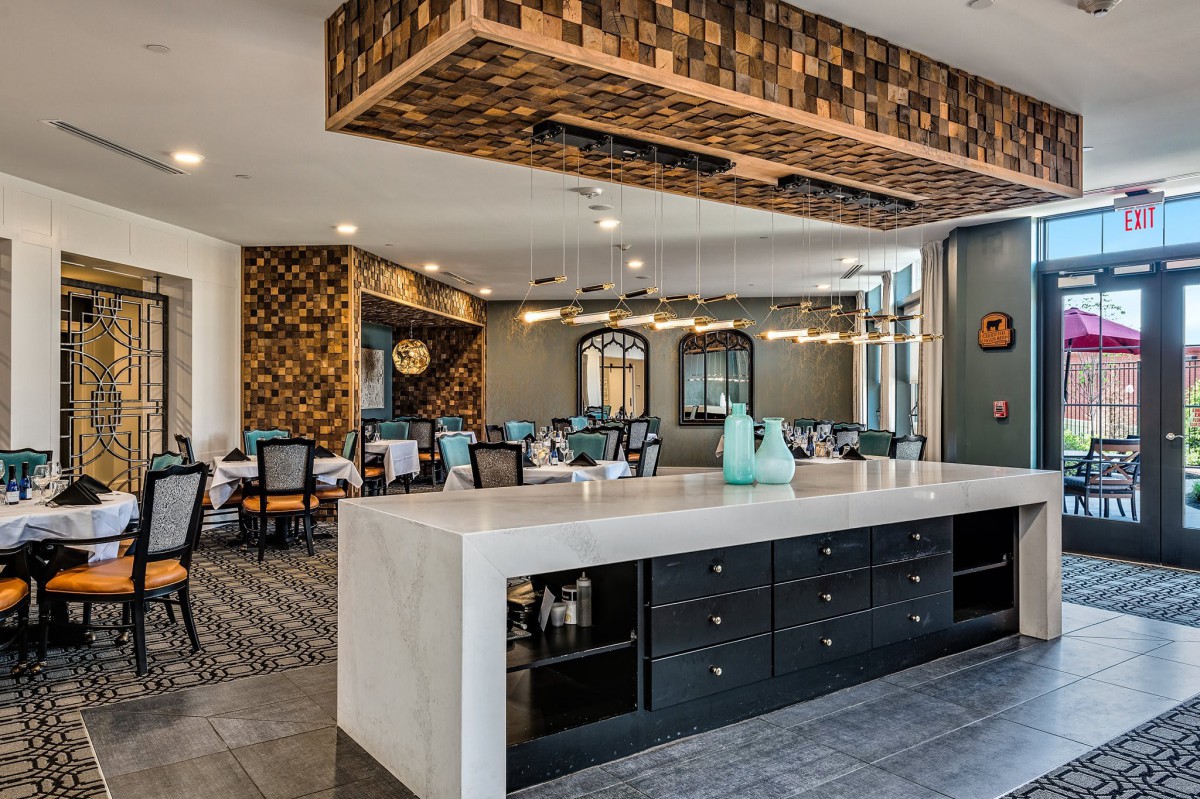 A stylish and modern kitchen and dining area with elegant lighting and sleek furniture.