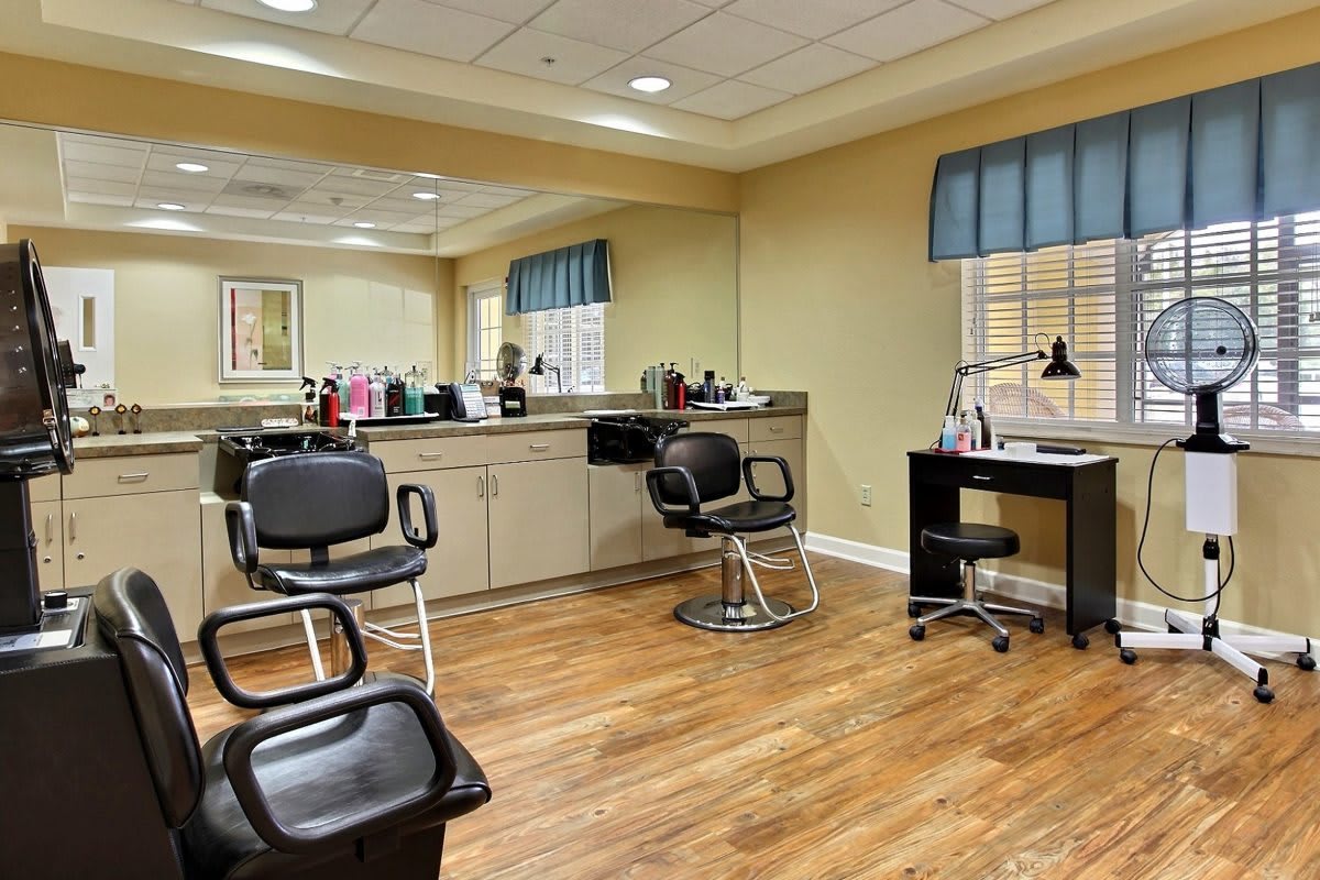 A well-organized hair salon interior with barber chairs and styling stations.