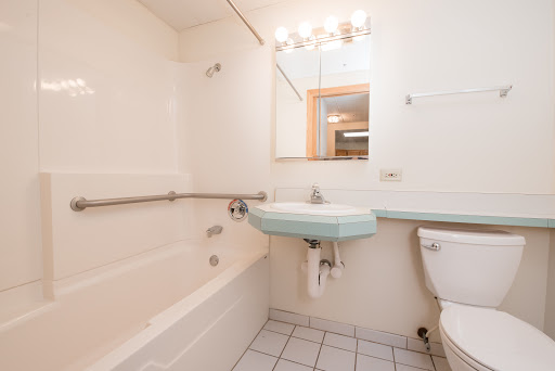 A simple and functional bathroom featuring a bathtub, sink, and toilet.