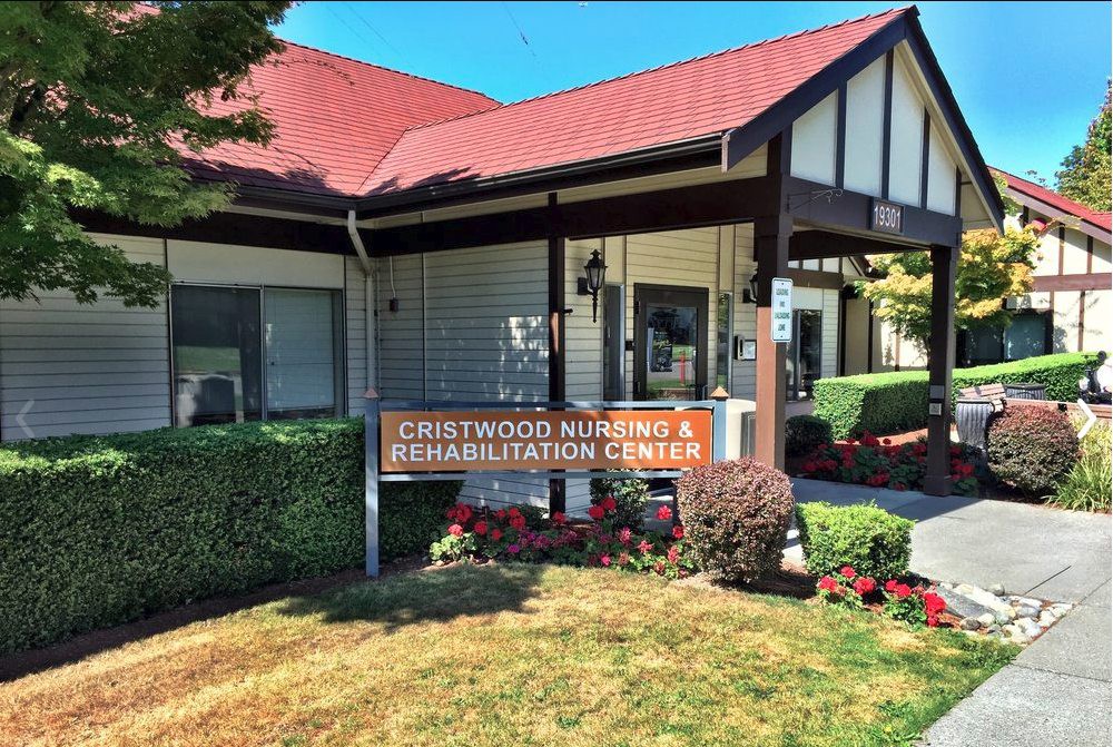 Exterior view of a nursing and rehabilitation center with well-maintained landscaping.