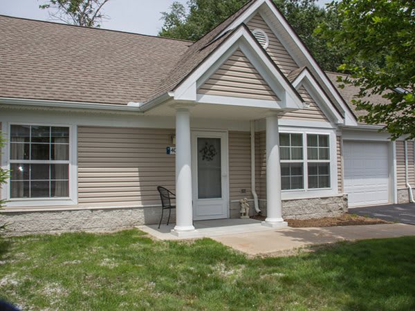 A suburban house with a porch and front yard.