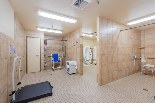 A spacious, accessible bathroom designed for both personal hygiene and exercise.