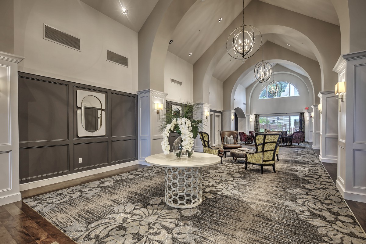 A spacious and elegantly designed lobby with high ceilings, modern decor, and comfortable seating.