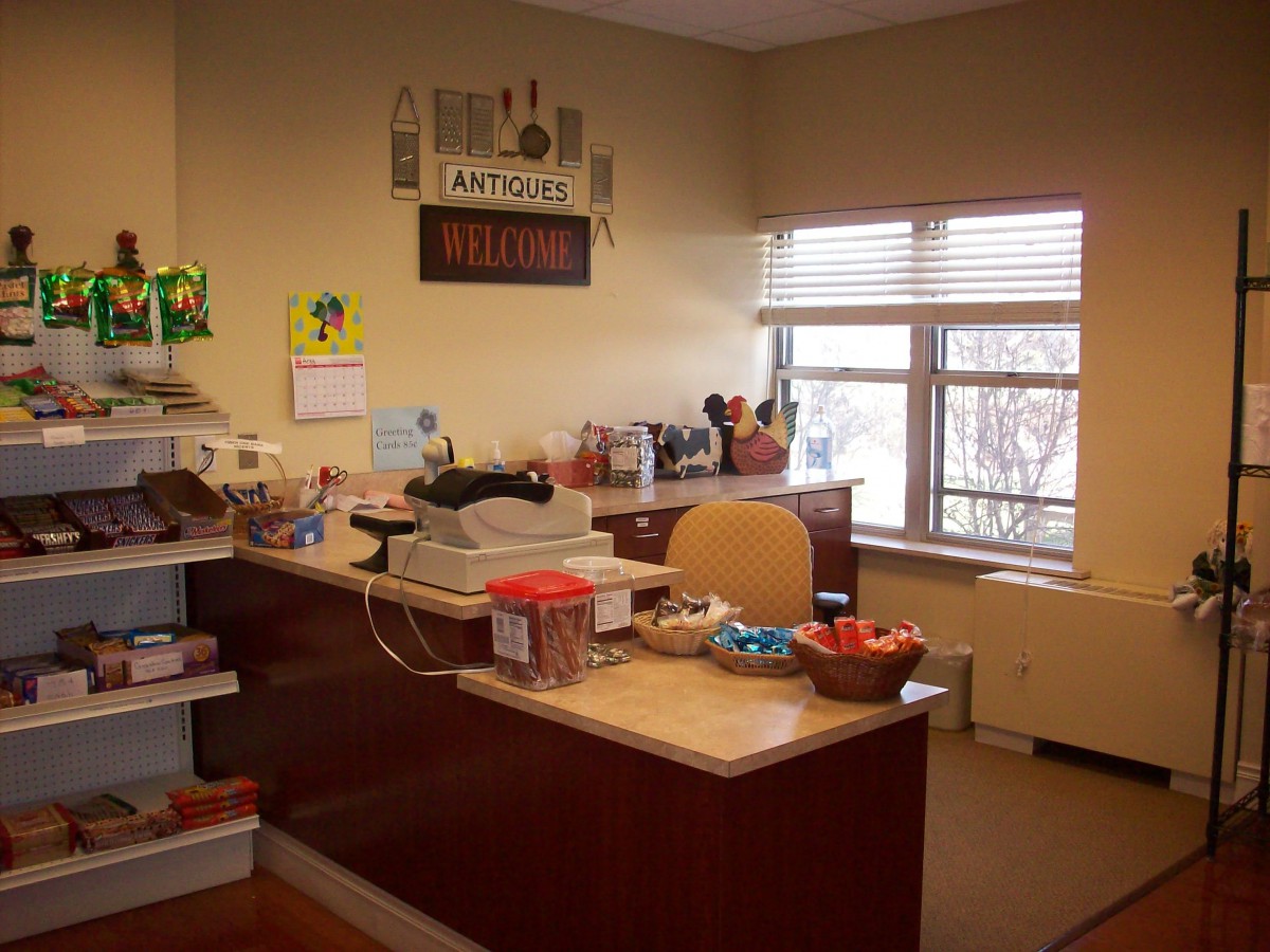 A cozy office reception area with a decorated desk and a window.