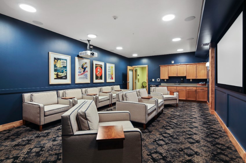 A modern waiting room with comfortable seating and artwork on the walls.