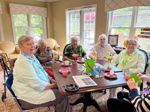 A cheerful gathering of seniors enjoying drinks and each other's company.