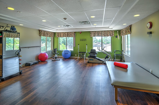 A well-lit exercise room equipped for fitness and rehabilitation activities.
