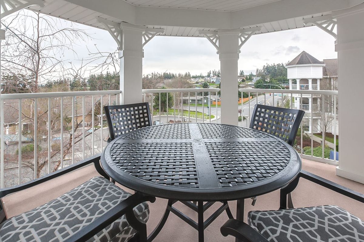 A cozy outdoor seating area in a gazebo overlooking a scenic landscape.