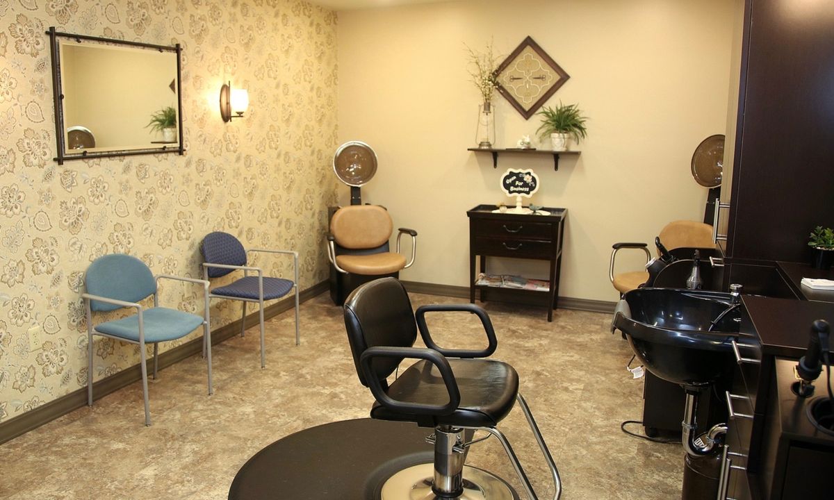 A cozy hair salon with a waiting area and styling chairs.