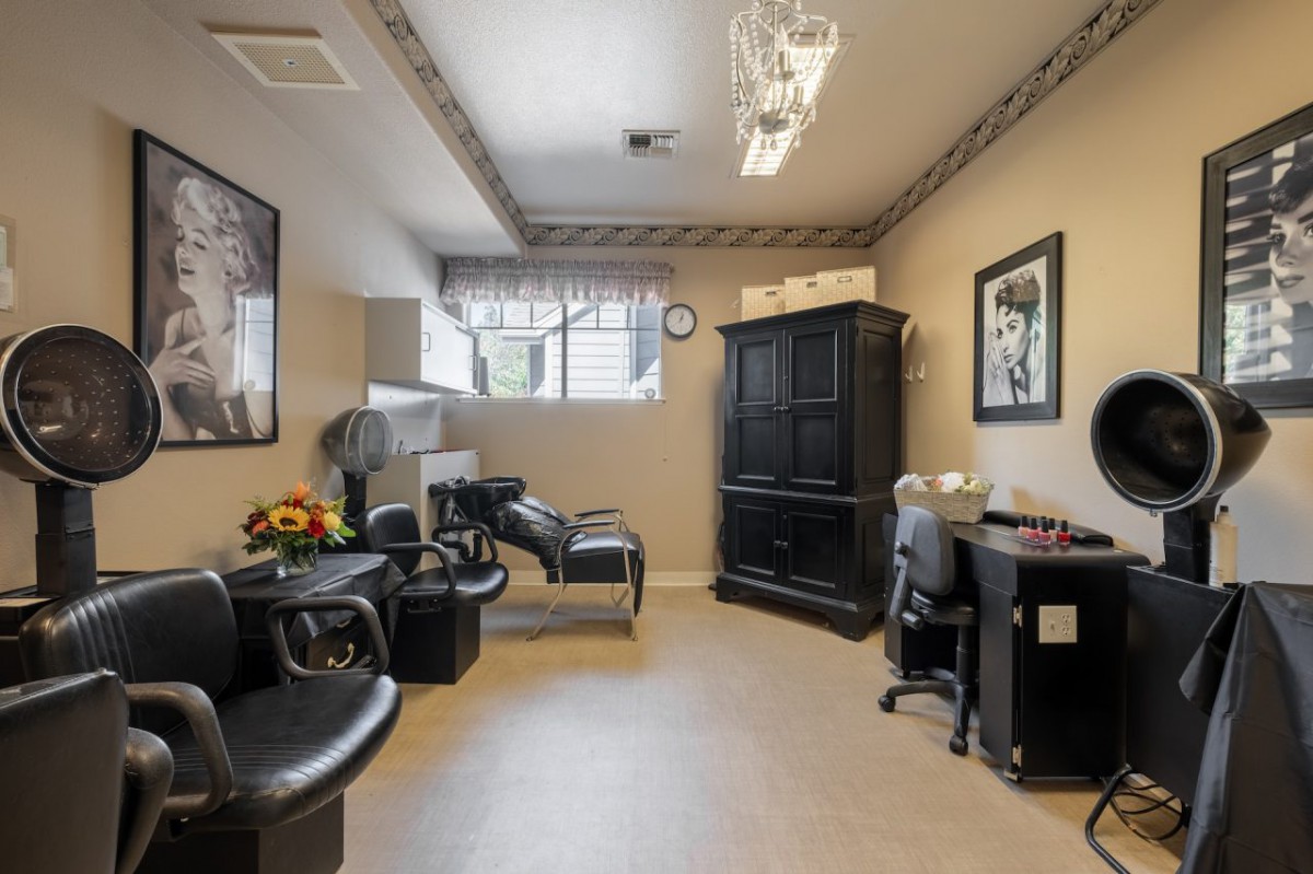 A modern and well-equipped salon interior with styling chairs and a workstation.