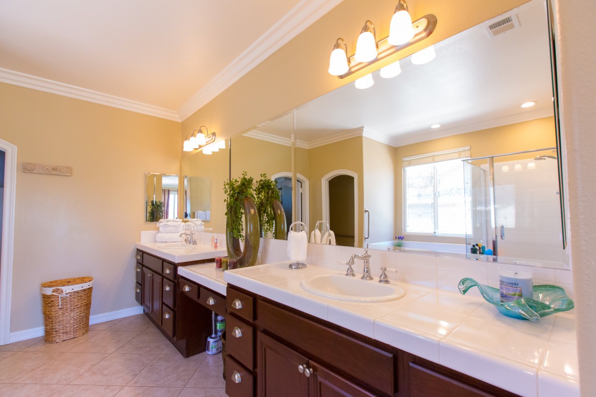 A spacious and well-lit bathroom with a double sink vanity.