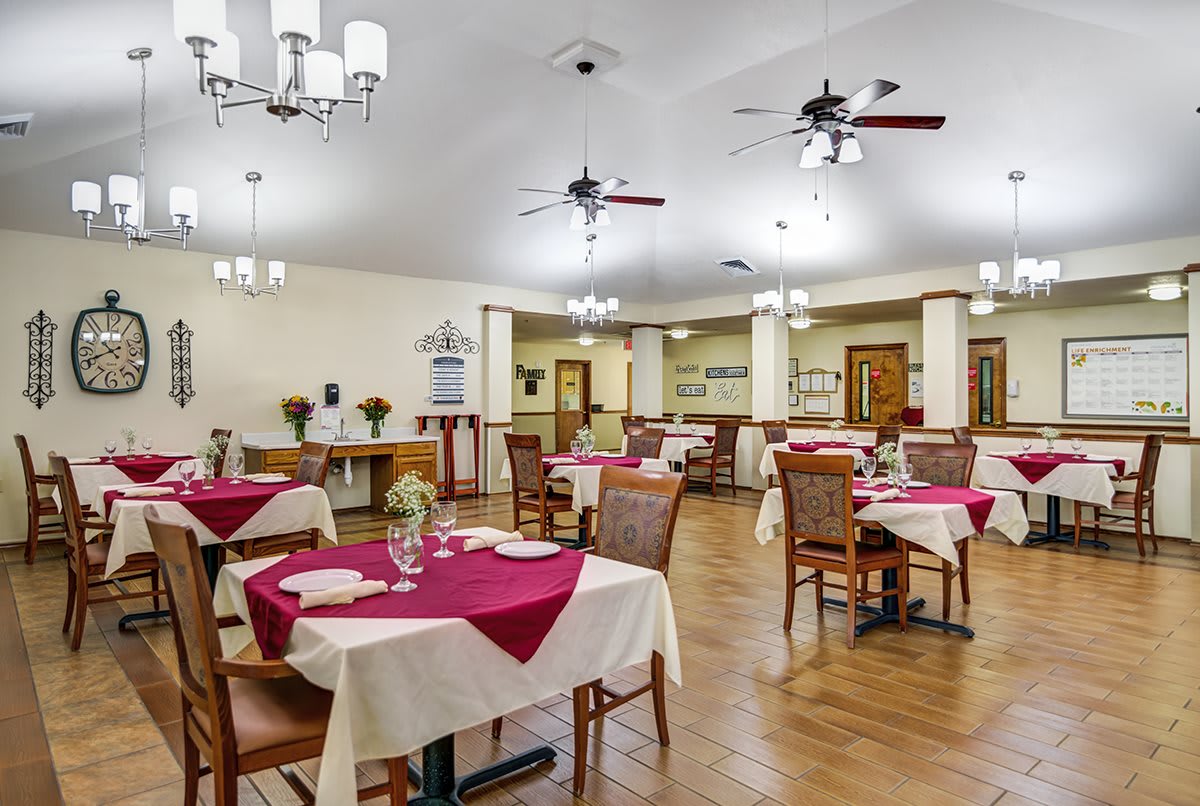 A well-decorated dining area with tables and chairs set for a meal.