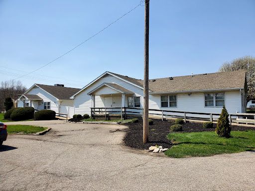 A sunny day view of a residential building with well-maintained landscaping.