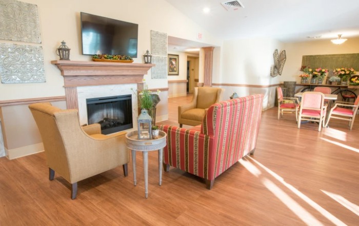 A cozy living room with a fireplace, television, and comfortable seating.