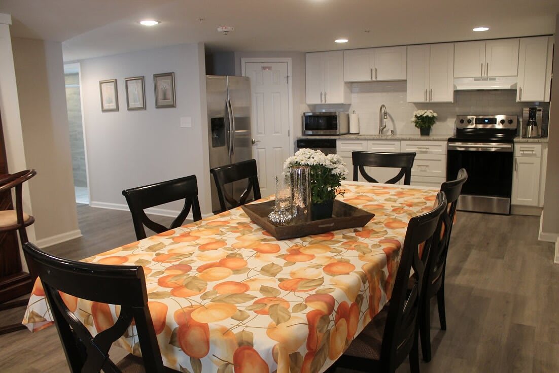 A cozy kitchen and dining area with a decorated table.